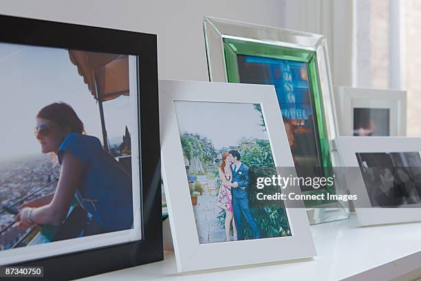 photographs on a mantelpiece - mantelpiece stock pictures, royalty-free photos & images