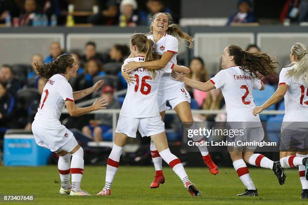 Jessie Fleming, Janine Beckie, Shelina Zadorsky and Allysha Chapman of Canada celebrate after Janine Beckie scored a goal against the United States...