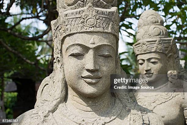stone statues - balinese headdress stock pictures, royalty-free photos & images