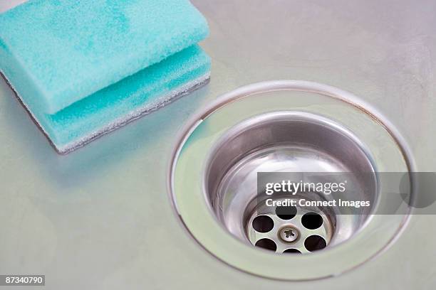 plug hole and sponge - abfluss stock-fotos und bilder