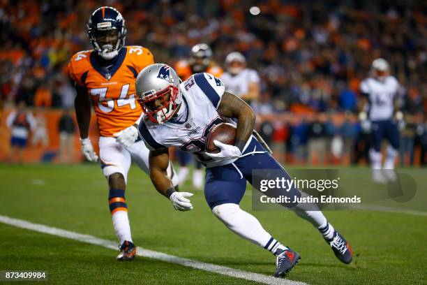 Running back James White of the New England Patriots has a fourth quarter touchdown catch against the Denver Broncos at Sports Authority Field at...
