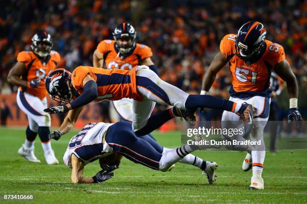 Strong safety Justin Simmons of the Denver Broncos flies after hitting wide receiver Danny Amendola of the New England Patriots in the fourth quarter...