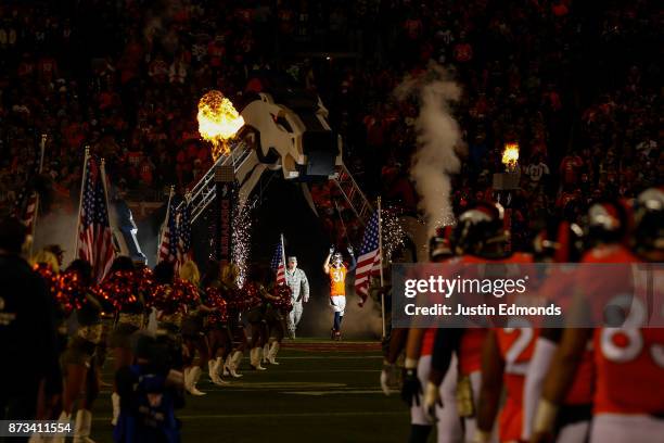 Strong safety Justin Simmons of the Denver Broncos walks onto the field during player introductions before a game against the New England Patriots at...