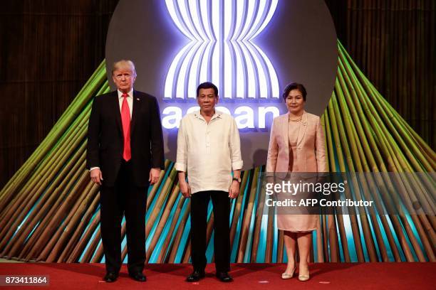 President Donald J. Trump, Philippine President Rodrigo Duterte and his partner Cielito Avanceno pose for photos before the opening ceremony of the...