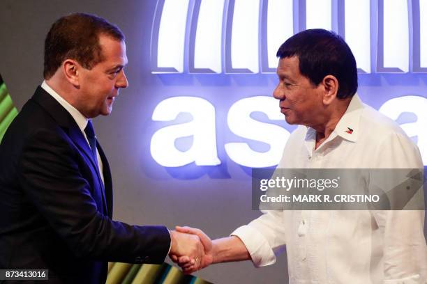 Russian Prime Minister Dmitry Medvedev shakes hands with Philippine President Rodrigo Duterte before the opening ceremony of the 31st Association of...