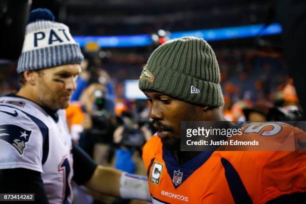 Quarterback Tom Brady of the New England Patriots has a word with outside linebacker Von Miller of the Denver Broncos after a 41-16 Patriots win at...