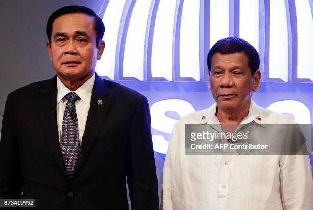 Thailand's Prime Minister Prayut Chan-o-cha and Philippine President Rodrigo Duterte pose for photos before the opening ceremony of the 31st...