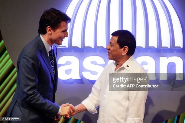 Canadian Prime Minister Justin Trudeau shakes hands with Philippine President Rodrigo Duterte before the opening ceremony of the 31st Association of...