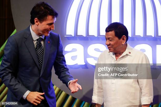 Canadian Prime Minister Justin Trudeau talks to Philippine President Rodrigo Duterte before the opening ceremony of the 31st Association of Southeast...