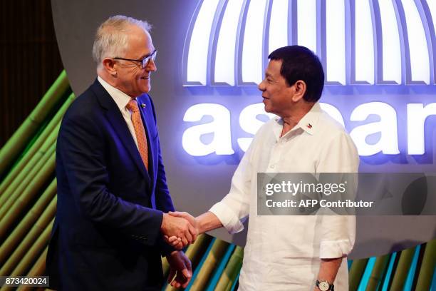 Australia's Prime Minister Malcolm Turnbull shakes hands with Philippine President Rodrigo Duterte before the opening ceremony of the 31st...