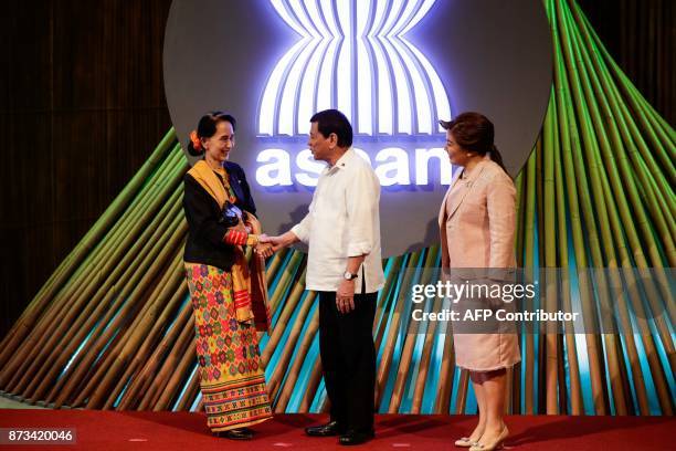 Myanmar's State Councellor and Foreign Minister Aung San Suu Kyi shakes hands with Philippine President Rodrigo Duterte before the opening ceremony...