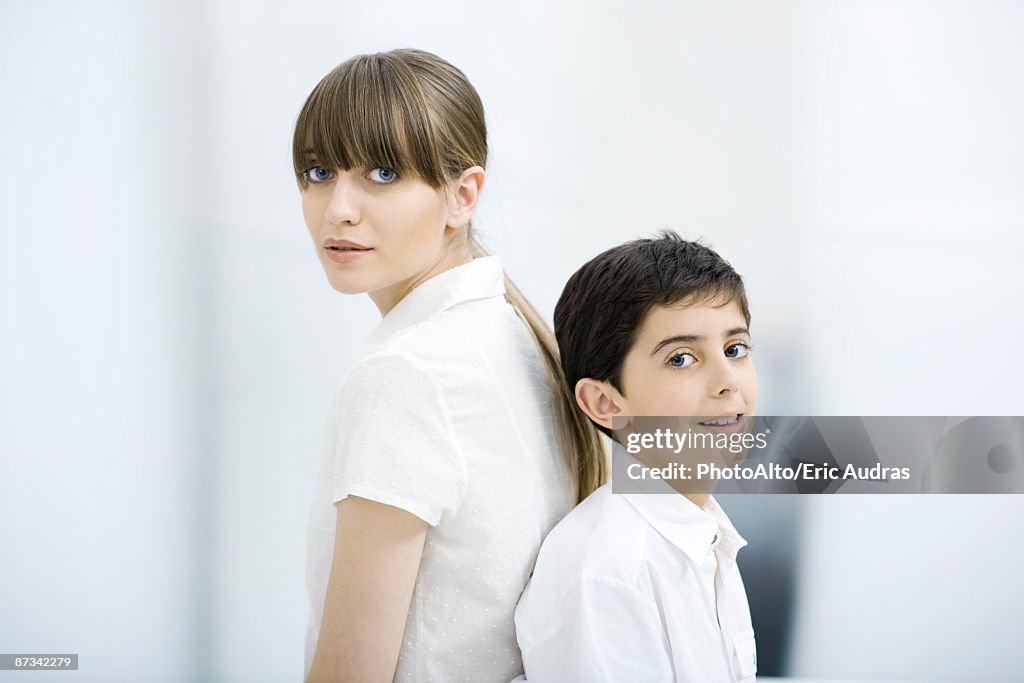 Mother and son back to back, portrait