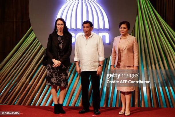 New Zealand's Prime Minister Jacinda Ardern, Philippine President Rodrigo Duterte and his partner Cielito Avanceno pose for photos before the opening...