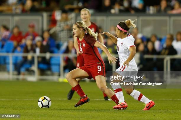 Lindsey Horan of the United States evades Desiree Scott of Canada during a friendly match at Avaya Stadium on November 12, 2017 in San Jose,...