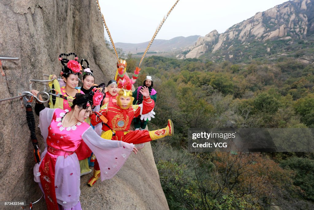 Newlywed Couple Poses For Wedding Photos On Cliff Face In Zhumadian