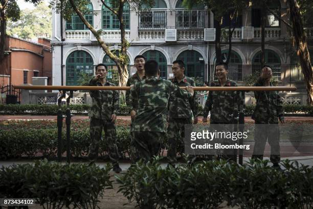 Soldiers from the People's Liberation Army react while performing exercises at a park in Shamian Island in Guangzhou, China, on Thursday, Nov. 2,...