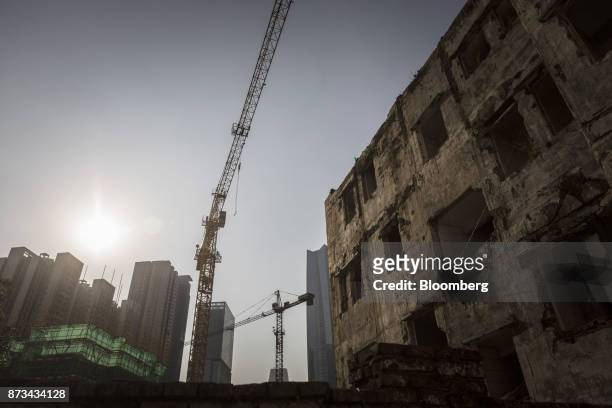 Cranes operate near vacant houses in Xi Cun, an old neighborhood slated for demolition and redevelopment in Guangzhou, China, on Wednesday, Nov. 1,...