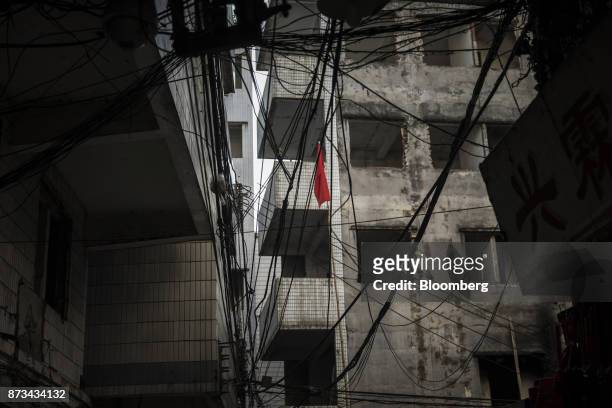 Red flag hangs on a pole next to electric wires in Xi Cun, an old neighborhood slated for demolition and redevelopment in Guangzhou, China, on...