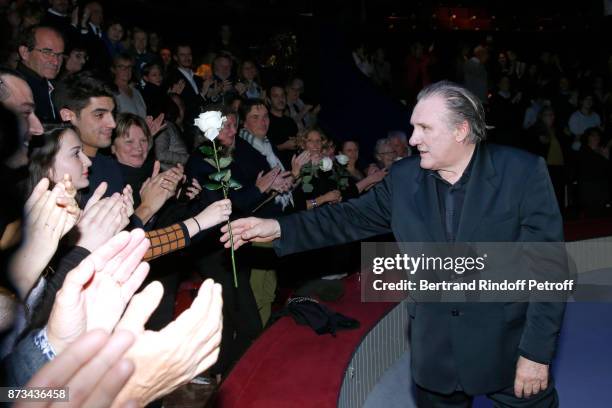 Gerard Depardieu acknowledges the applause of the audience and gives flowers to his fans at the end of attend "Depardieu Chante Barbara" at "Le...