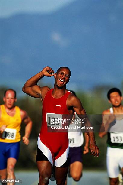 track and field, runner winning sprint race - athlete winning stock pictures, royalty-free photos & images