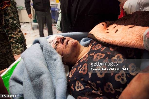 Victim receives treatment at a hospital following a 7.3-magnitude earthquake in Sarpol-e Zahab in Iran's western province of Kermanshah on November...