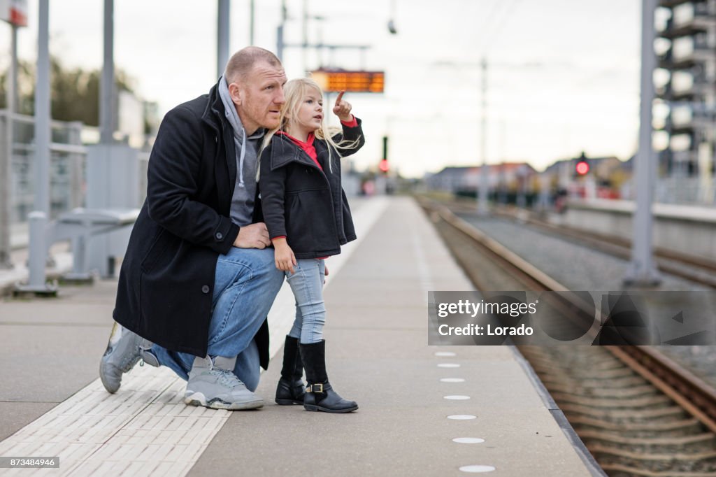 Handsome redhead middle aged father and cute blonde daughter traveling on public transport
