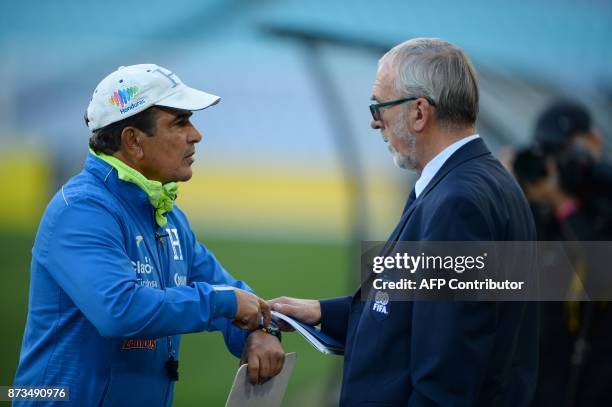 Honduras' national coach Jorge Luis Pinto talks to a FIFA official about media coverage of a football training session at the ANZ Stadium in Sydney...