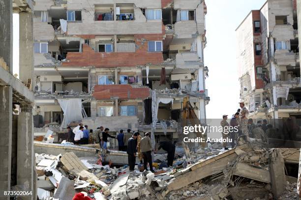 Civilians and soldiers search for the possible survivors trapped under the debris in Sarpol-e Zahab town of Kermanshah, Iran on November 13, 2017...