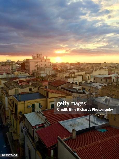 skyline and roof tops of corato, puglia, italy at sunset - ancorato stock pictures, royalty-free photos & images