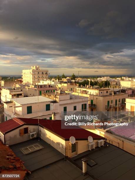 skyline and roof tops of corato, puglia, italy at sunset - ancorato stock pictures, royalty-free photos & images