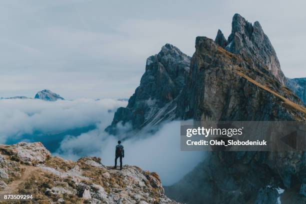 man hiking near seceda mountain in dolomites - summit stock pictures, royalty-free photos & images