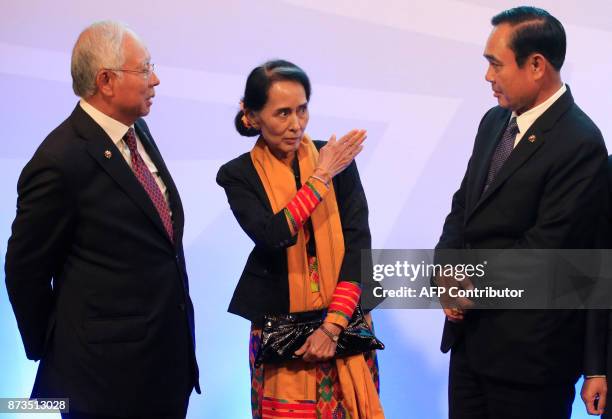 Myanmar's State Councellor and Foreign Minister Aung San Suu Kyi , gestures while talking to Thailand's Prime Minister Prayut Chan-o-Cha and...