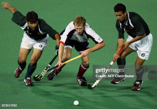 Saqlain Mohammad and Hussain Dilawar of Pakistan race Ben Taylor of an Australian A line-up to the ball in their game at a tri-nations challenge...