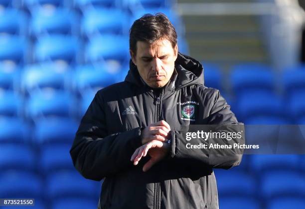 Manager Chris Coleman watches checks the time on his watch during the Wales Press Conference and Training Session at The Cardiff City Stadium on...