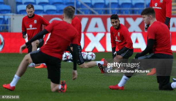 Neil Taylor warms up with team mate during the Wales Press Conference and Training Session at The Cardiff City Stadium on November 13, 2017 in...