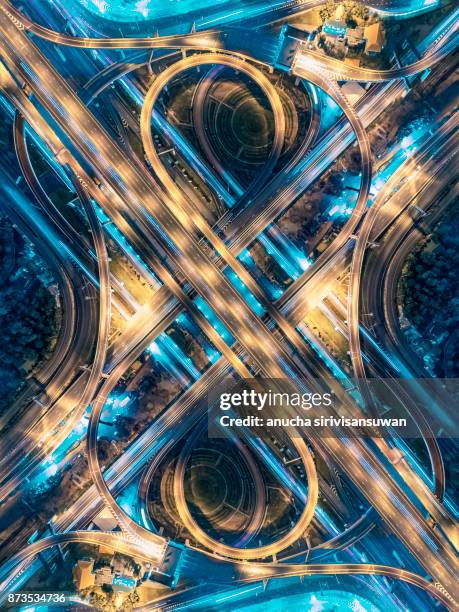 road beautiful aerial view of busy intersection at night , top view , thailand . - highways stock-fotos und bilder