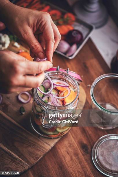 preserving organic cauliflower, carrots and tomatoes in jars - pickle relish stock pictures, royalty-free photos & images