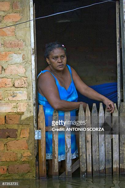 Woman stands in her flooded house in Bacabal, in the state of Maranhao, northern Brazil, on May 15, 2009. Around a million people lost their houses...