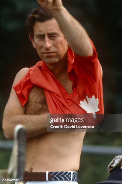 Prince Charles changes his shirt at Cowdray Park Polo Club in Sussex on August 2, 1982.