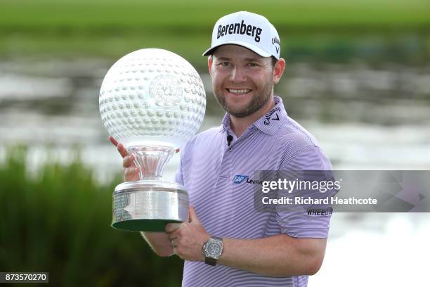 Branden Grace of South Africa poses with the trophy after his victory during the final round of the 2017 Nedbank Golf Challenge at Gary Player CC on...