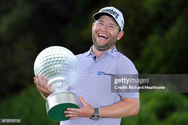 Branden Grace of South Africa poses with the trophy after his victory during the final round of the 2017 Nedbank Golf Challenge at Gary Player CC on...