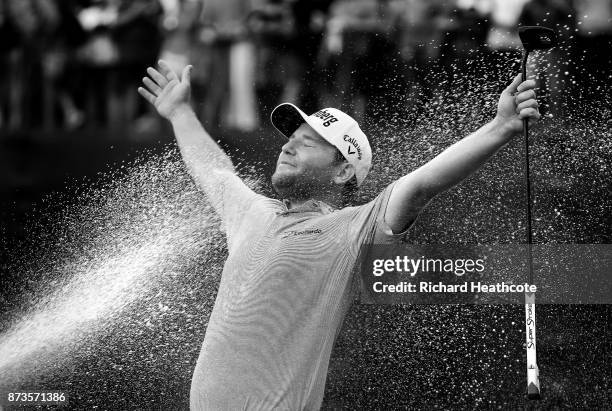 Branden Grace of South Africa is sprayed with champagne after his victory during the final round of the 2017 Nedbank Golf Challenge at Gary Player CC...