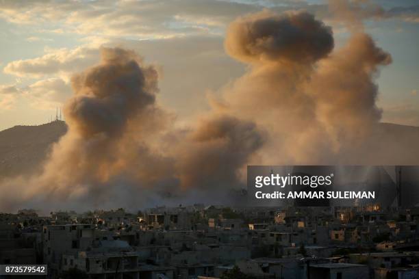 Smoke rises from buildings following a reported strike on a rebel-held area of the Jobar district, east of the Syrian capital on November 11, 2017.
