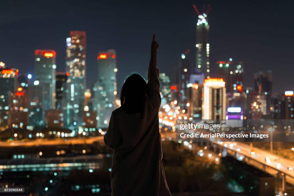 Young Female Standing in Front of Modern City