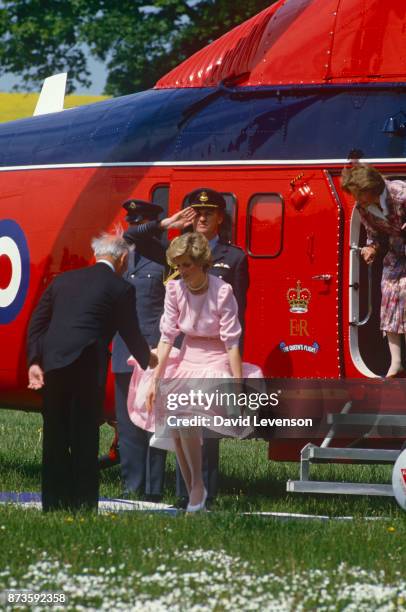 Diana Princess of Wales has a gust of wind blow her skirt up, as she gets off her Queens Flight helicopter, at the Poolemead centre for the Deaf on...