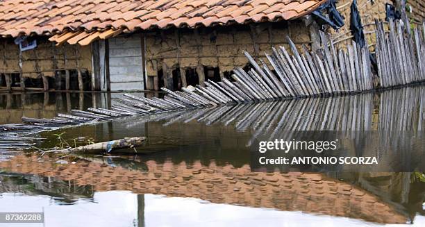 Damaged house reflects in a street flooded by the Mearim river in Bacabal, in the state of Maranhao, northern Brazil, on May 15, 2009. Around a...