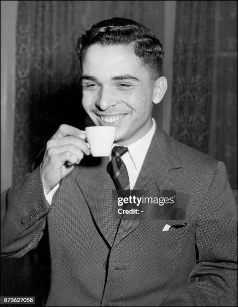 Hussein Ibn Talal, King of Jordan cadet of Royal Military Academy in Sandhurst, England, smiles as he sips a coup of coffee, 01 November 1952 in the...