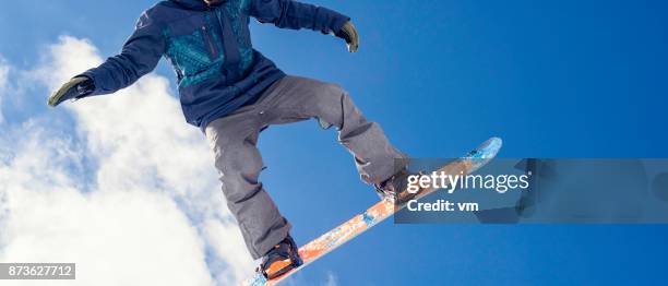 close up of snowboarder in mid-air - snowboard jump close up stock pictures, royalty-free photos & images