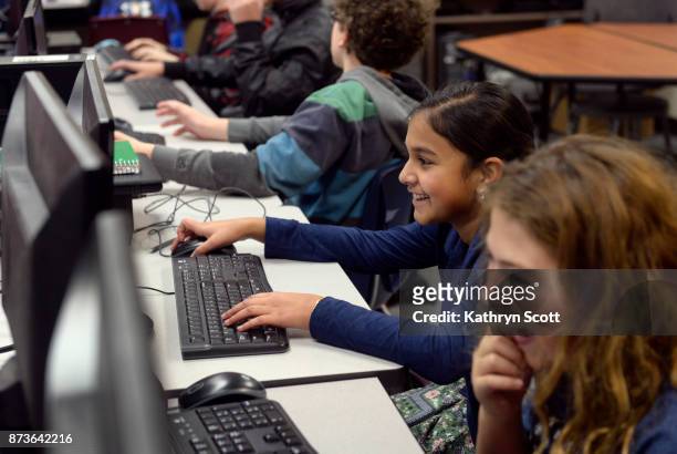 Gitanjali Rao second from right, works on assignments with fellow students in her 7th-grade computer science class at the STEM School Highlands Ranch...