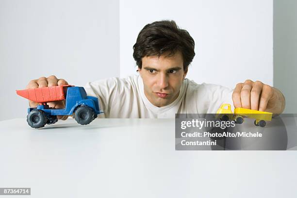 man playing with toy trucks - toy adult stock pictures, royalty-free photos & images